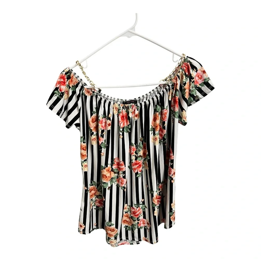 Women’s black and white blouse with floral print and detail with chain straps.